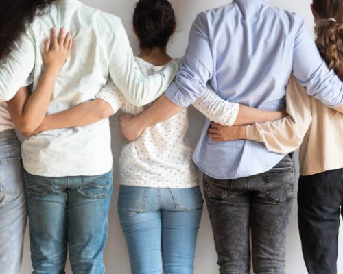 Diverse people, men and women standing back close up, embracing, colleagues, students team group showing union and support, teamwork, best friends hugging, posing for photo, equality concept